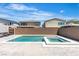 Backyard featuring a modern pool and spa with grey brick pavers in an outdoor living space at 11228 Burning River St, Las Vegas, NV 89183
