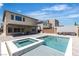 Backyard oasis with a sparkling pool, hot tub, and outdoor seating area at 11228 Burning River St, Las Vegas, NV 89183