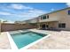 Backyard featuring a modern pool with a spa and large grey paver patio at 11228 Burning River St, Las Vegas, NV 89183