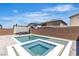 Backyard featuring a modern pool and spa with grey brick pavers in an outdoor living space at 11228 Burning River St, Las Vegas, NV 89183