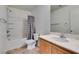 Bathroom features a shower-tub combo and a vanity with a sink and a marble countertop at 11668 Tierney Creek Dr, Las Vegas, NV 89183