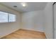 Bedroom featuring light wood-look laminate flooring, neutral walls and a window at 11668 Tierney Creek Dr, Las Vegas, NV 89183
