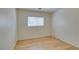 Bedroom featuring light wood-look laminate flooring, neutral walls and a window at 11668 Tierney Creek Dr, Las Vegas, NV 89183