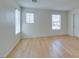 Bedroom with light walls, wood flooring, and two windows at 11668 Tierney Creek Dr, Las Vegas, NV 89183