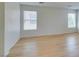 Bedroom with two windows, wood flooring and light walls at 11668 Tierney Creek Dr, Las Vegas, NV 89183