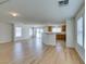 Open bonus room with wood floors, natural light, and seamless flow to kitchen at 11668 Tierney Creek Dr, Las Vegas, NV 89183