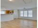 Open-concept living space with wood floors, breakfast bar, and multiple windows at 11668 Tierney Creek Dr, Las Vegas, NV 89183