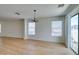Spacious dining area with wood floors, natural light from multiple windows and sliding glass door at 11668 Tierney Creek Dr, Las Vegas, NV 89183
