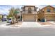 Two-story home featuring a neutral-colored exterior, two car garage and a well-maintained front yard at 11668 Tierney Creek Dr, Las Vegas, NV 89183