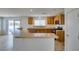 Spacious kitchen with breakfast bar, wood cabinets, and an open flow to the adjacent living space at 11668 Tierney Creek Dr, Las Vegas, NV 89183
