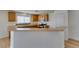 Open kitchen with breakfast bar, wood cabinets, stainless appliances, for seamless cooking and dining at 11668 Tierney Creek Dr, Las Vegas, NV 89183