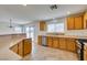Kitchen features a breakfast bar, stainless steel appliances, and wood cabinetry with bright, natural light at 11668 Tierney Creek Dr, Las Vegas, NV 89183