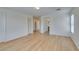 Open floor plan with wood floors, light walls, doors and hallway access at 11668 Tierney Creek Dr, Las Vegas, NV 89183