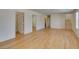 Open living space with hardwood floors, white walls, and staircase access at 11668 Tierney Creek Dr, Las Vegas, NV 89183