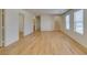 Open living space featuring hardwood floors, multiple doorways, and staircase access at 11668 Tierney Creek Dr, Las Vegas, NV 89183