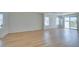Spacious open-concept living room featuring light wood-look laminate flooring and sliding door access to the patio at 11668 Tierney Creek Dr, Las Vegas, NV 89183