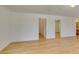 Open living area with wood floors, white walls and several doorways at 11668 Tierney Creek Dr, Las Vegas, NV 89183
