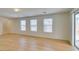 Open-concept living room featuring light wood-look laminate flooring and plenty of natural light at 11668 Tierney Creek Dr, Las Vegas, NV 89183