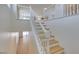 Light and bright staircase with white railings and wood stairs at 11668 Tierney Creek Dr, Las Vegas, NV 89183