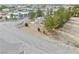 Aerial view of house highlights well-maintained xeriscaping, RV parking, and mature trees at 151 Hornet St, Pahrump, NV 89048