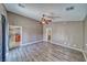 Large primary bedroom boasts laminate floors and great natural light from multiple windows at 151 Hornet St, Pahrump, NV 89048