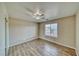 Cozy bedroom with wood-look flooring, ceiling fan, and window offering natural light at 151 Hornet St, Pahrump, NV 89048