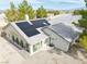 Home with modern solar panels, large windows, patio and neutral stucco in a well-kept private backyard at 151 Hornet St, Pahrump, NV 89048