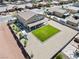 Aerial view of a spacious backyard, including lush grass, playground, patio, and parking for RV at 1512 Sagefield Way, Logandale, NV 89021