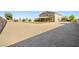 Large backyard with ample space, including a well-maintained lawn, playground, and expansive gravel area at 1512 Sagefield Way, Logandale, NV 89021