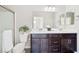 Bathroom features a double sink vanity with white countertop and a glass enclosed shower at 1512 Sagefield Way, Logandale, NV 89021