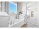 Bright bathroom featuring a soaking tub with modern fixtures and a view to the yard at 1512 Sagefield Way, Logandale, NV 89021