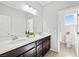 Bathroom featuring double sink vanity with granite countertops, modern fixtures, and bright lighting at 1512 Sagefield Way, Logandale, NV 89021