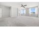 Carpeted bedroom with neutral walls, ceiling fan, and large windows for natural light at 1512 Sagefield Way, Logandale, NV 89021