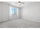 Bright bedroom featuring carpeted floors, neutral walls, and a large window at 1512 Sagefield Way, Logandale, NV 89021