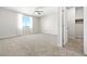 Spacious bedroom with plush carpeting, large window with sheer curtains and adjacent closet at 1512 Sagefield Way, Logandale, NV 89021
