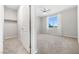 Bedroom with plush carpeting, ceiling fan and bright window with a walk in closet at 1512 Sagefield Way, Logandale, NV 89021