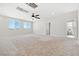 Bright, carpeted bonus room featuring natural light, ceiling fan, and an attached bathroom at 1512 Sagefield Way, Logandale, NV 89021