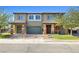 Inviting two-story home with a brick driveway, manicured lawn, and stone pillar accents at 1512 Sagefield Way, Logandale, NV 89021