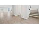 Bright foyer featuring wood-look floors, neutral walls, and staircase leading to the upper level at 1512 Sagefield Way, Logandale, NV 89021