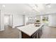 Bright open-plan kitchen with a large center island, dark wood cabinets, and lots of light at 1512 Sagefield Way, Logandale, NV 89021