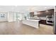 Open-concept kitchen with stainless steel appliances, center island, and access to the patio at 1512 Sagefield Way, Logandale, NV 89021
