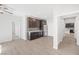 Open-concept kitchenette featuring dark cabinets, sleek appliances, and wood flooring throughout at 1512 Sagefield Way, Logandale, NV 89021