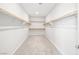 Walk-in closet featuring built-in shelving and carpeted flooring at 1512 Sagefield Way, Logandale, NV 89021