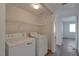 Bright laundry room with washer and dryer and wire shelving at 3953 Rebecca Raiter Ave # 202, Las Vegas, NV 89110