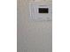 Close-up of a Honeywell thermostat on a textured wall at 3953 Rebecca Raiter Ave # 202, Las Vegas, NV 89110
