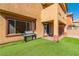Backyard featuring artificial grass, a built-in BBQ grill, and access to the house at 41 Stablewood Ct, North Las Vegas, NV 89084