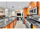 Open concept kitchen with stainless steel appliances, a large island and barstool seating at 41 Stablewood Ct, North Las Vegas, NV 89084