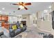 Open concept living room featuring plush seating, a fan and natural light at 41 Stablewood Ct, North Las Vegas, NV 89084