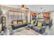 Comfortable living room with plush seating, a ceiling fan and a view into the kitchen at 41 Stablewood Ct, North Las Vegas, NV 89084