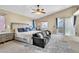 Spacious main bedroom featuring a ceiling fan, couch, sliding glass door, and ensuite bathroom at 41 Stablewood Ct, North Las Vegas, NV 89084